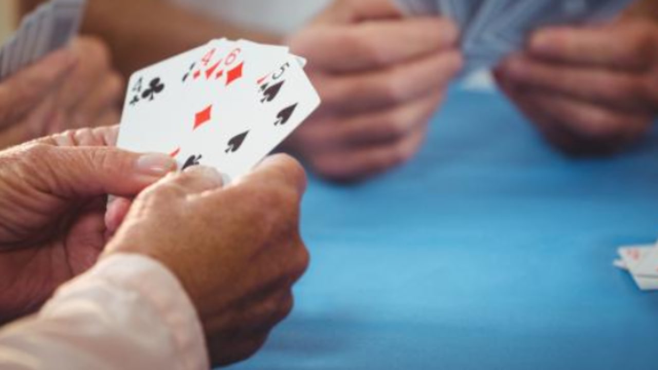 Elderly people play cards and then argue